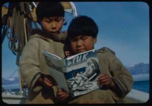 Image of Two Eskimo [Inuit] boys on the Bowdoin looking at ”Etuk”