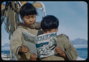 Image of Two Eskimo [Inuit] boys on the BOWDOIN look at ”Etuk”