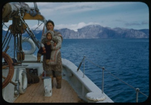Image of Eskimo [Inuit] mother and baby boy by the wheel