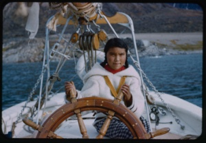 Image of Eskimo [Inuk] girl at wheel