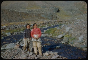 Image of Young women and boy by stream