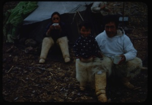 Image of Eskimo [Inuit] couple and child by tent