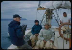 Image of Donald MacMillan, Harrigan [Inukitooq], Ootaq with another Eskimo [Inuk] man at wheel