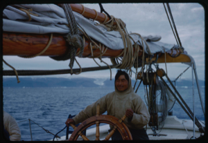 Image of Eskimo [Inuk] man at wheel