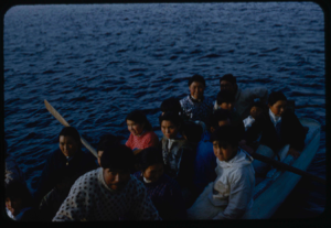 Image of Eskimos [Inuit] in open boat coming to visit