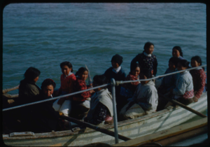 Image of Eskimos [Inuit] in open boat along side