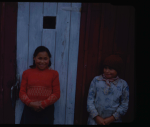 Image: Two Eskimo [Inuit] girls by wooden building