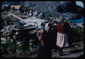 Image: Two Eskimo [Inuit] women and a child; barrel dump beyond