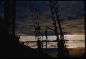 Image of Cloud effect in setting sun, through rigging