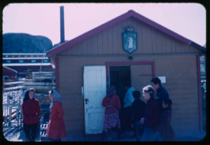 Image: Group of Inuit outside frame shed