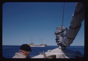 Image of Two-masted Portuguese fishing vessel; Donald MacMillan on The Bowdoin in foreground