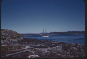 Image of Bowdoin, moored. Small boats on land