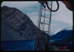 Image of Snow-capped coastal mountain through rigging; also striations