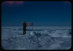 Image: Peter Rand standing with flag at farthest north