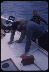Image of Dr. William Powers and ? studying chart