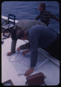 Image: Dr. William Powers and ? studying chart