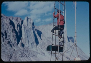 Image of Stanton Cook in rigging, close to mountain