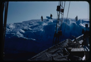 Image of Bowdoin tied to iceberg, Miriam MacMillan and others on iceberg getting water