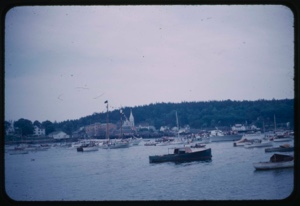 Image of The Bowdoin at departure surrounded by small boats for escort