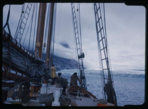 Image of Glacier through rigging; crew on deck