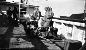 Image of Matthew Henson, Donald MacMillan, George Borup, and Tom Gushue, all in furs, aboard SS Roosevelt