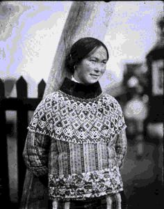 Image of Eskimo [Inuk] woman by jaw-bone arch