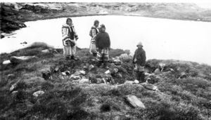 Image of 4 Inuit in sealskin clothing