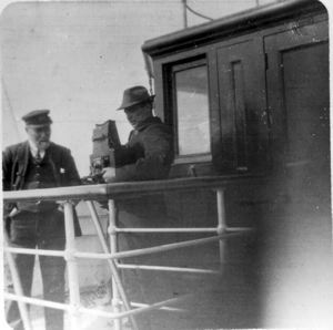 Image: Unidentified man and MacMillan with large camera 