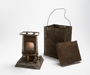 Image of Portable stove with tin container, wire handle and cover
