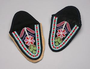 Image: Innu moccasin vamp - black with floral beaded design: red, green, white, blue, 