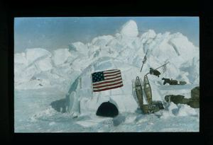 Image of Eighth camp on the Polar Sea [Igdlu on Polar Sea, with flag, snowshoes and equipment]