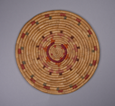 Image of Small round mat with red, blue, purple, orange and brown design