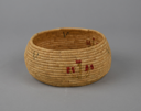 Image of Coiled grass basket with red and green plants on sides and 3 small blue designs