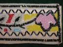 Image of Belt beaded in multi-color floral pattern with black and white border.