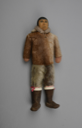 Image of male doll with dressed in sealskin hooded parka, breeches, and boots