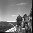Image of Crew watching iceberg with binoculars at Battle Harbor