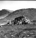 Image of Eskimo [Inuit] family and igloo [iglu], Meteorite Is., Savigsuit
