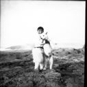 Image of Boy holding dog, Thule