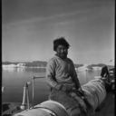 Image of Eskimo [Inuk] at rail, Inglefield Fjord