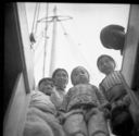 Image of Kahta family looking down hatch, Thule