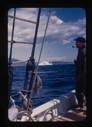 Image of Al Barnes on deck. Iceberg through rigging