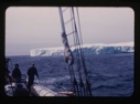Image of iceberg through rigging, MacMillan and Barney on deck