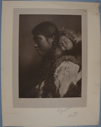 Image of North Alaskan adult female with braids, with baby in her hood