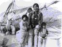 Image of Eskimo [Inuit] Family (Mother and children aboard)