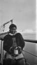 Image of Eskimo [Inuk] woman with mug, on deck