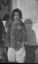 Image of Eskimo [Inuk] boy on deck wearing polar bear pants