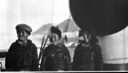 Image of Three Eskimo [Inuit] boys smoking, on deck