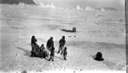 Image of Eskimo [Inuit] family with sledge. Igloo [iglu] being constructed in foreground