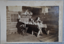 Image of Interior of a log cabin with men at a dining table.