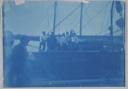 Image of Group of men on vessel at dock, cyanotype